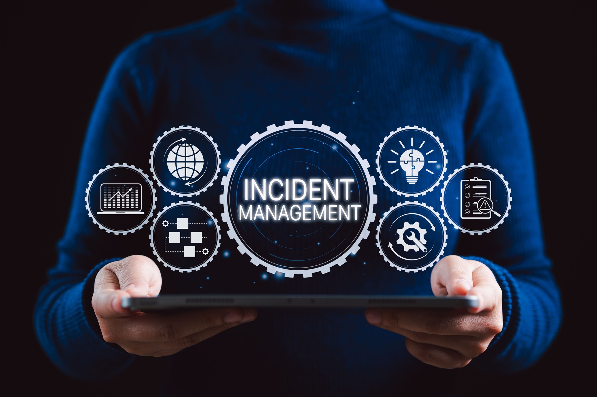 Incident Management System Technology Concept. A person holding tablet with interface Incident Management, icons symbolizing analytics, strategy, process, risk assessment, and problem resolution.
